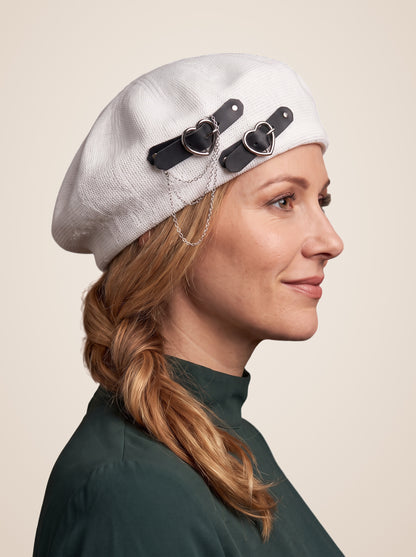 Double Heart Buckle Chain Beret in White, worn by a model, three quarter view
